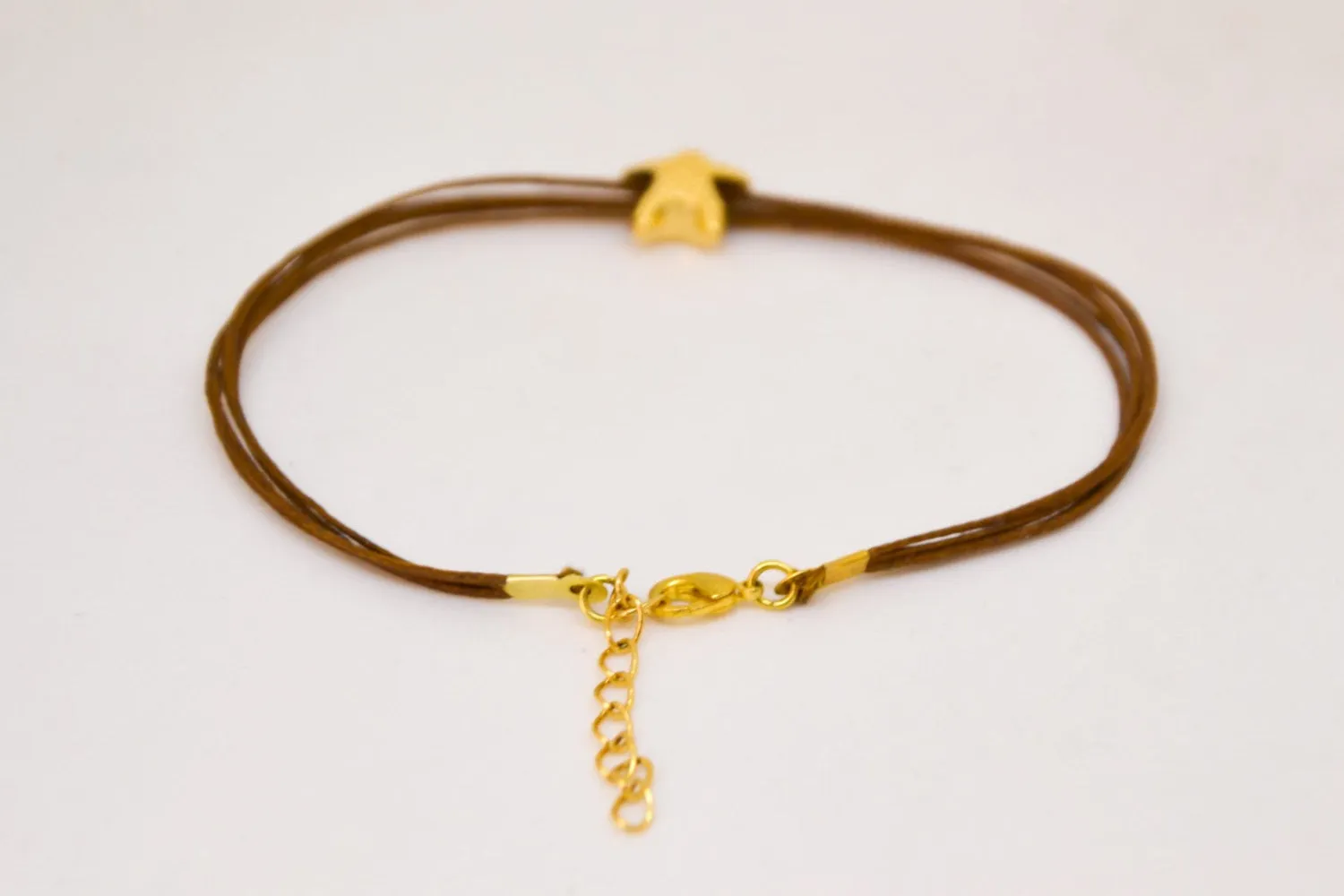 Ankle bracelet with gold plated starfish charm, brown string